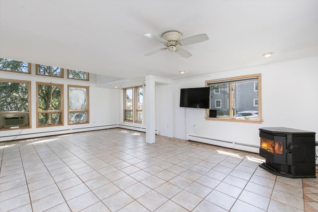 16 Crescent Avenue Beverly, MA 01915 - Photo 6 of 37 a view of an empty room with a window and a kitchen area