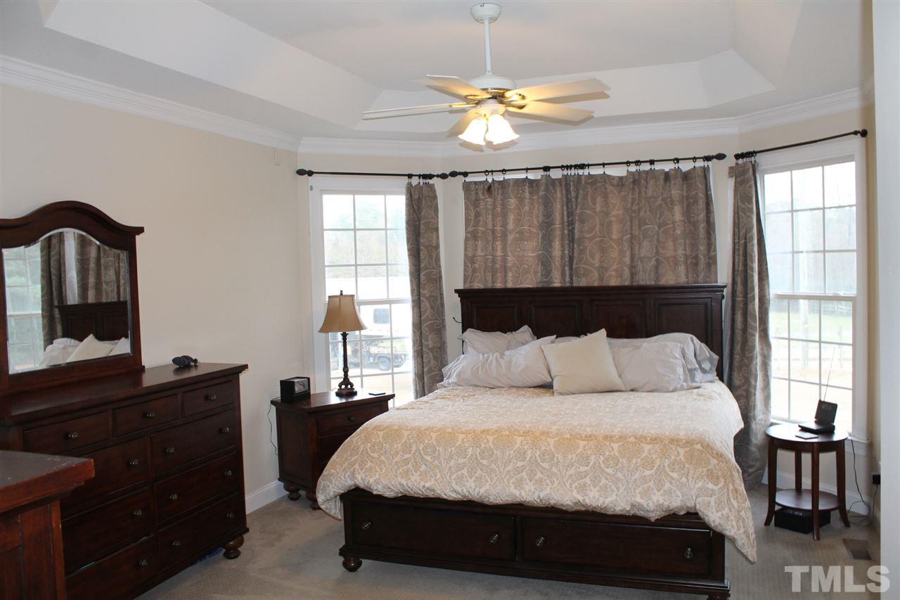 2601 Federal Road Benson, NC 27504 - Photo 12 of 24 a bedroom with a bed lamps and a large mirror