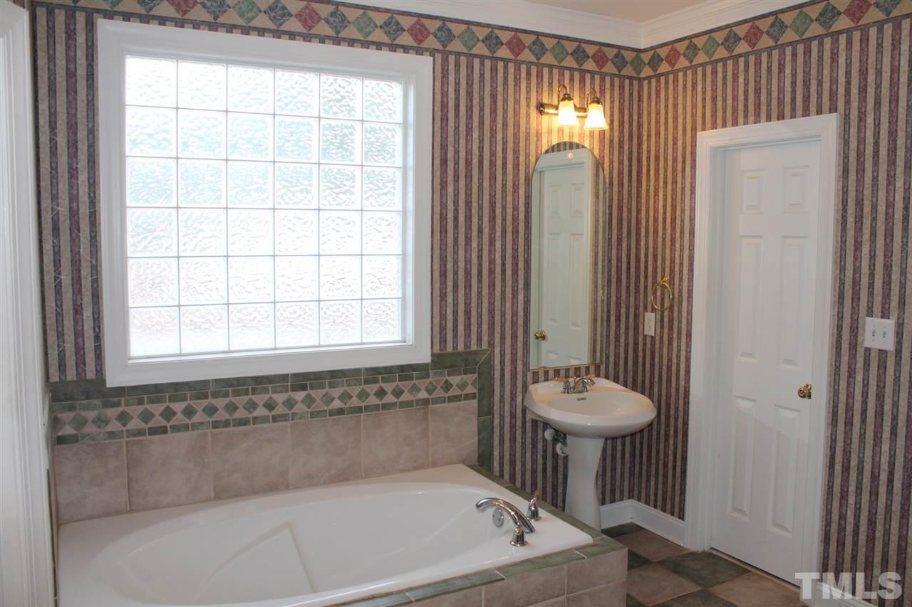 2601 Federal Road Benson, NC 27504 - Photo 15 of 24 a bathroom with a tub and shower