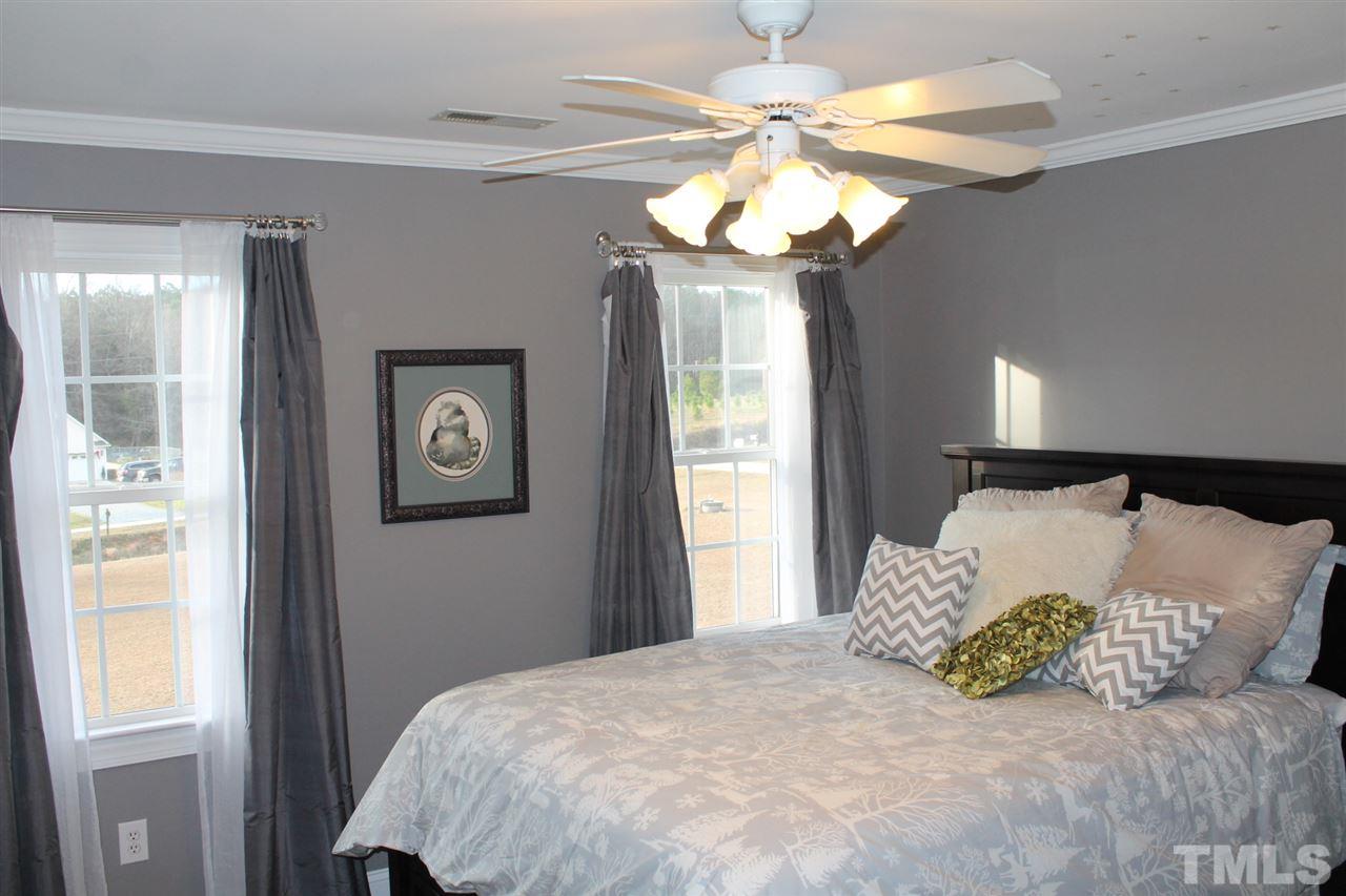2601 Federal Road Benson, NC 27504 - Photo 19 of 24 a bedroom with a bed and a chandelier