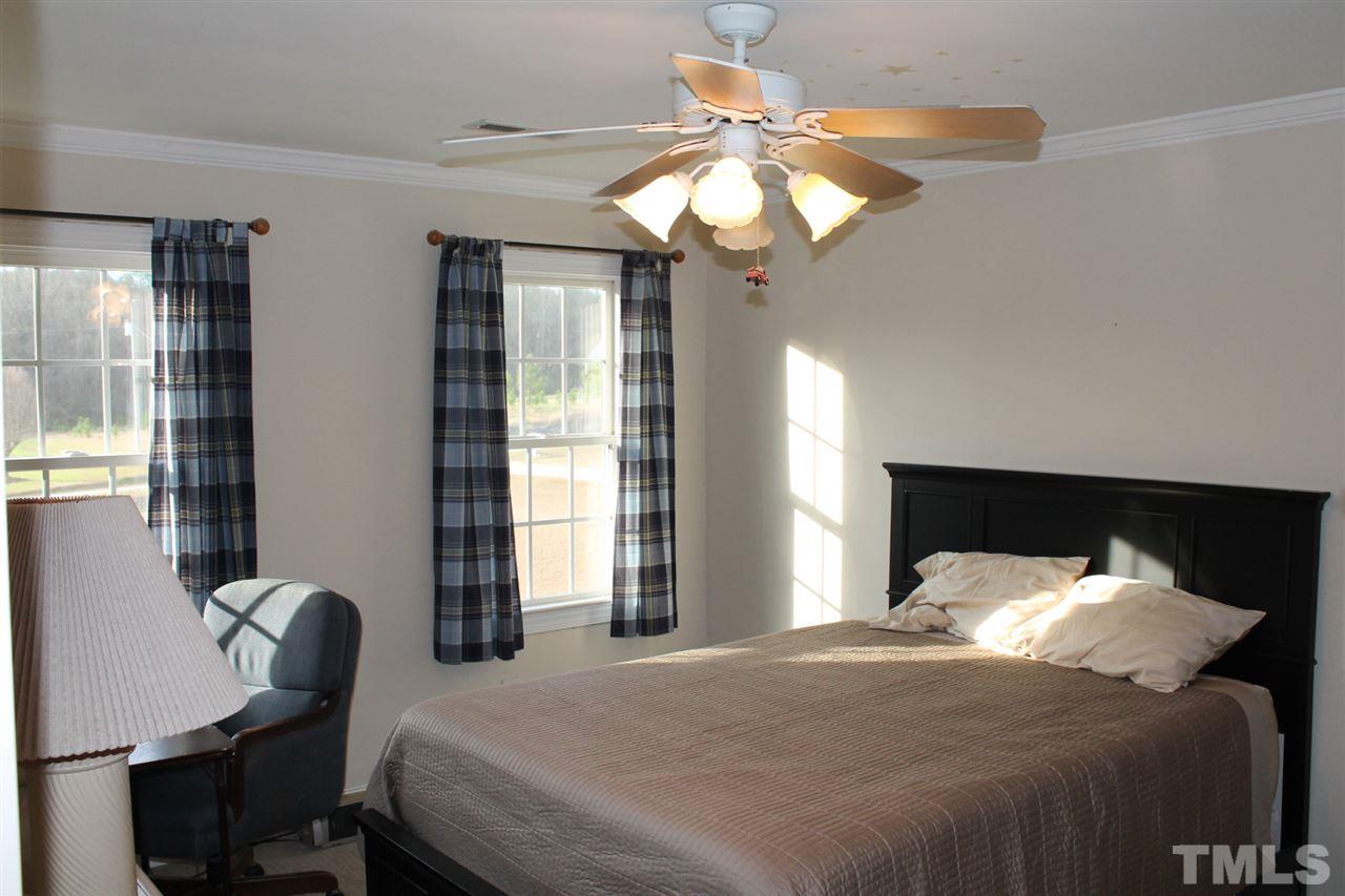 2601 Federal Road Benson, NC 27504 - Photo 20 of 24 a bedroom with a bed and a chair
