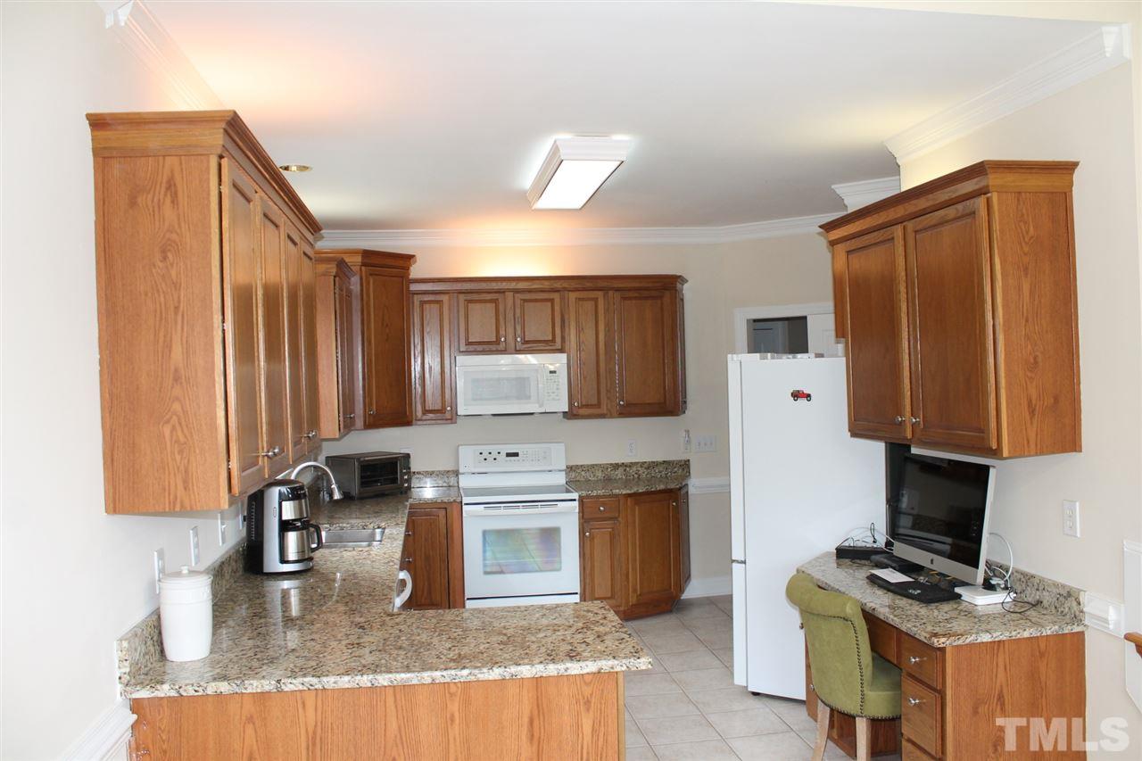 2601 Federal Road Benson, NC 27504 - Photo 3 of 24 a kitchen with granite countertop a sink stove and refrigerator