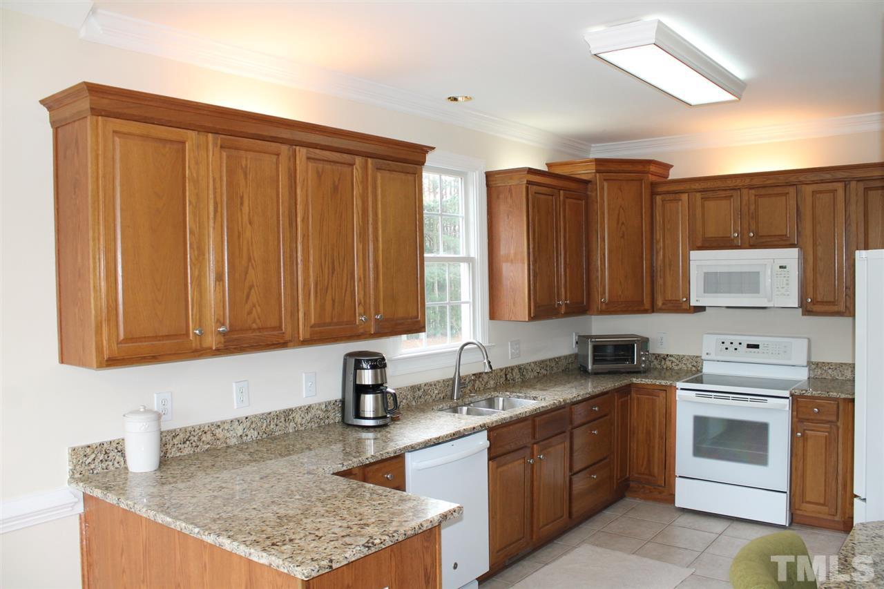 2601 Federal Road Benson, NC 27504 - Photo 4 of 24 a kitchen with stainless steel appliances granite countertop a sink stove and refrigerator
