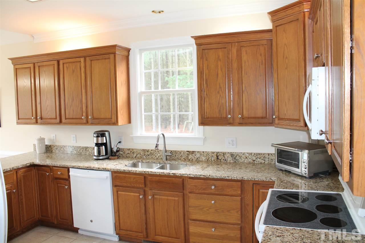 2601 Federal Road Benson, NC 27504 - Photo 5 of 24 a kitchen with granite countertop a sink a stove and cabinets