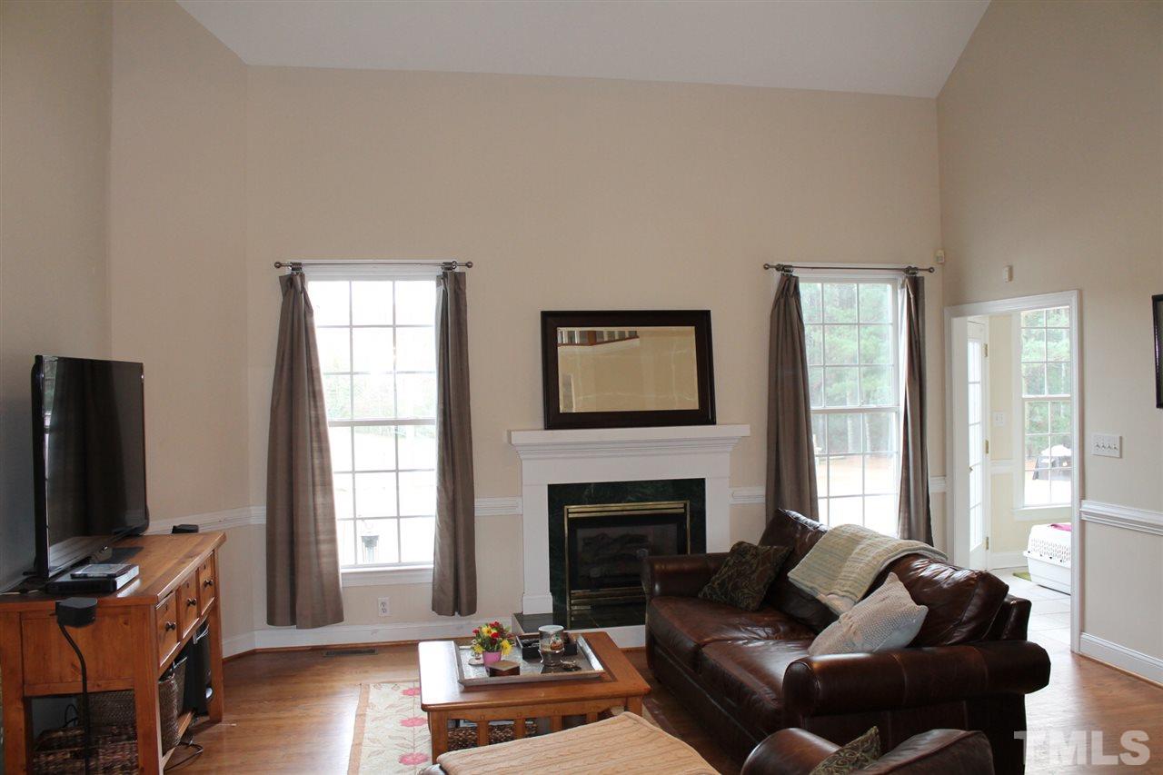 2601 Federal Road Benson, NC 27504 - Photo 9 of 24 a living room with furniture a flat screen tv and a fireplace