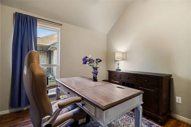 a hallway with wooden floor and a living room