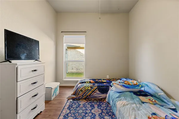 a view of bedroom with furniture and wooden floor
