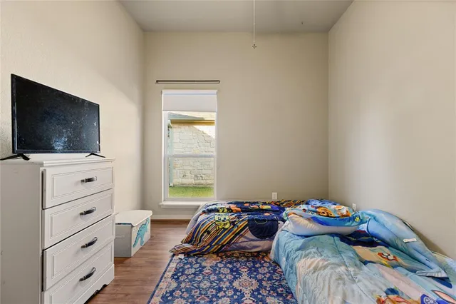 a view of bedroom with furniture and wooden floor