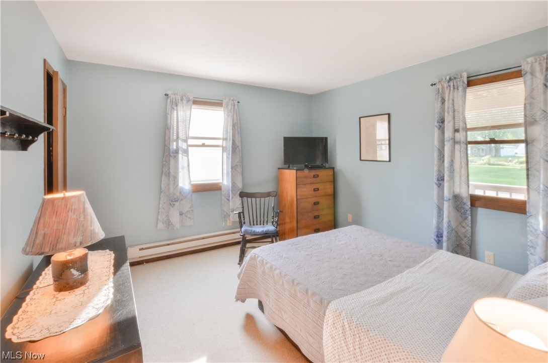 3120 West Elmore Road Port Clinton, OH 43452 - Photo 11 of 27 Carpeted bedroom featuring a baseboard radiator