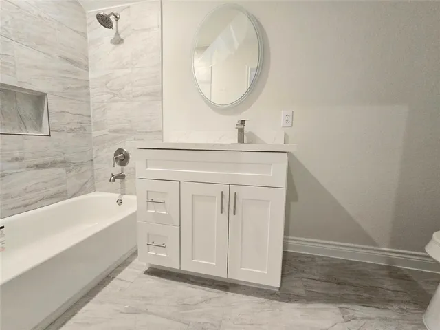 a spacious bathroom with a double vanity sink and a mirror
