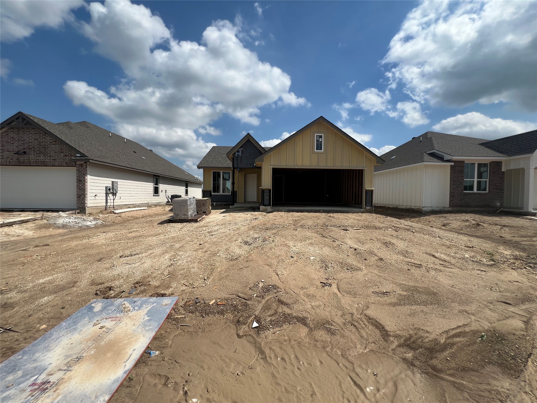251 Gus Loop Georgetown, TX 78626 - Photo 1 of 10 Two contemporary residences under construction, showcasing diverse architectural elements and roofing.