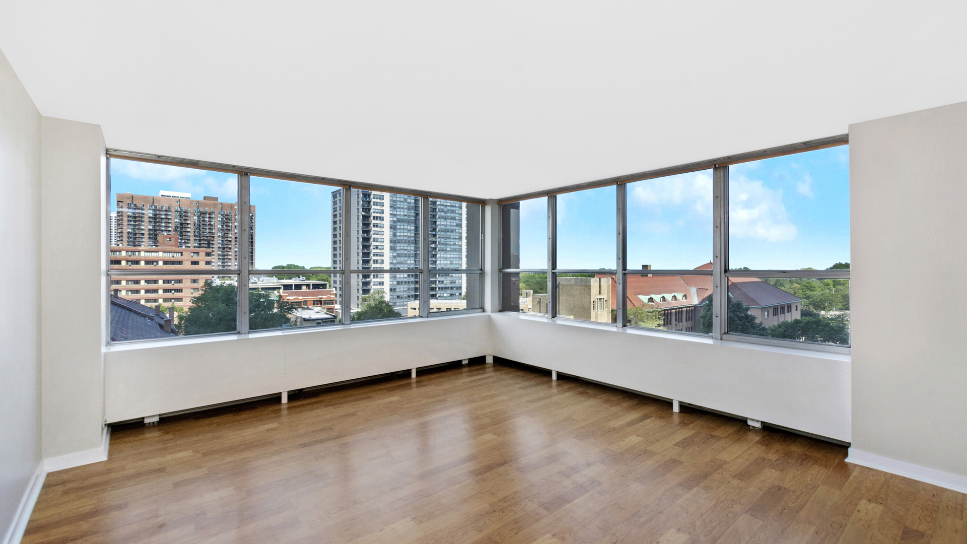 655 West Irving Park Road, Unit 710 Chicago, IL 60613 - Photo 2 of 24 an empty room with wooden floor and windows