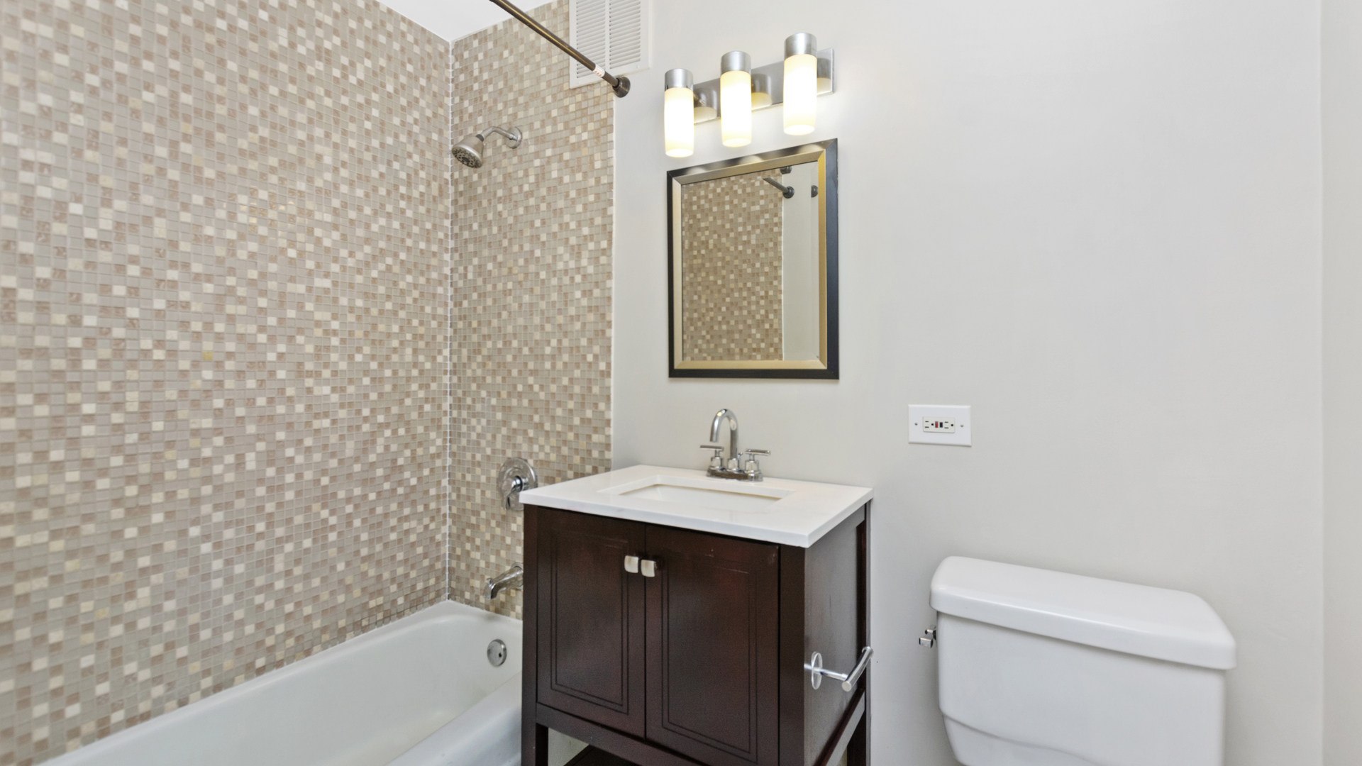 655 West Irving Park Road, Unit 710 Chicago, IL 60613 - Photo 12 of 24 a bathroom with a sink a toilet and shower