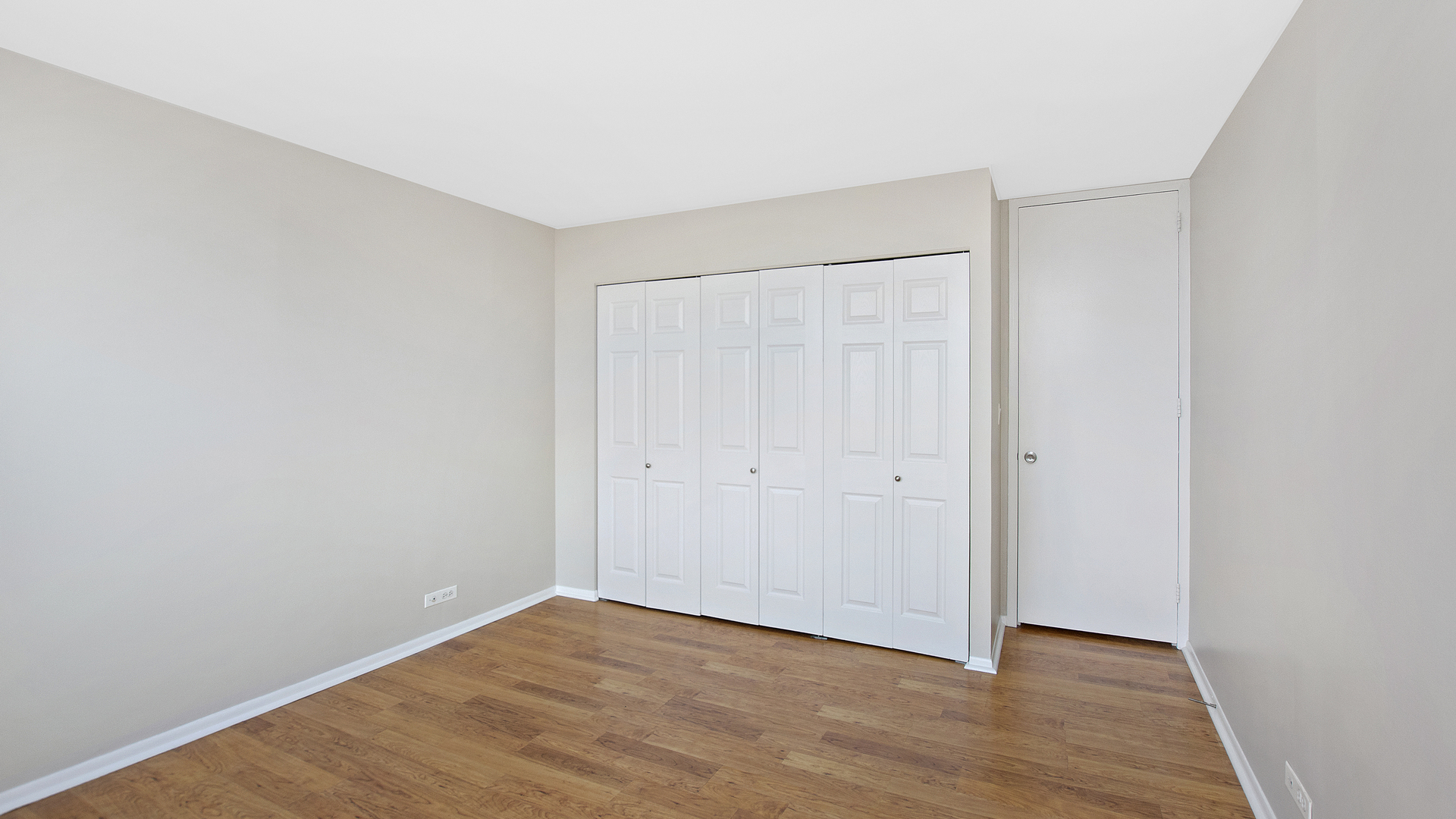 655 West Irving Park Road, Unit 710 Chicago, IL 60613 - Photo 14 of 24 a view of an empty room with wooden floor