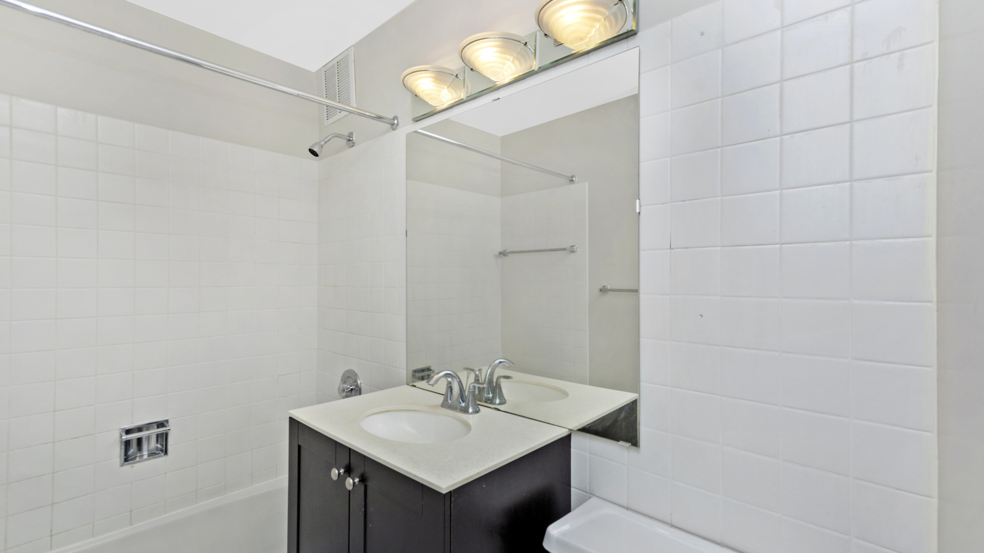 655 West Irving Park Road, Unit 710 Chicago, IL 60613 - Photo 15 of 24 a bathroom with a sink toilet and vanity