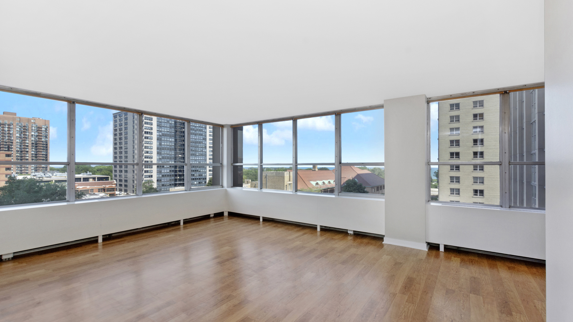 655 West Irving Park Road, Unit 710 Chicago, IL 60613 - Photo 3 of 24 wooden floor in an empty room with a window