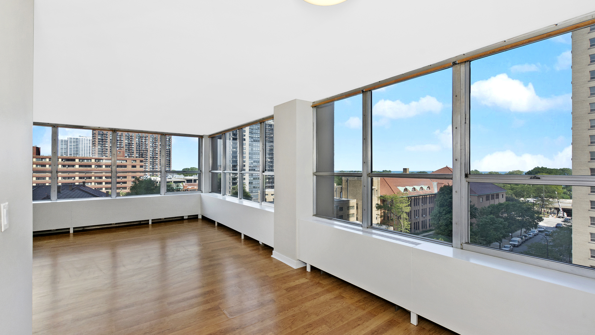 655 West Irving Park Road, Unit 710 Chicago, IL 60613 - Photo 5 of 24 a view of room with window and wooden floor