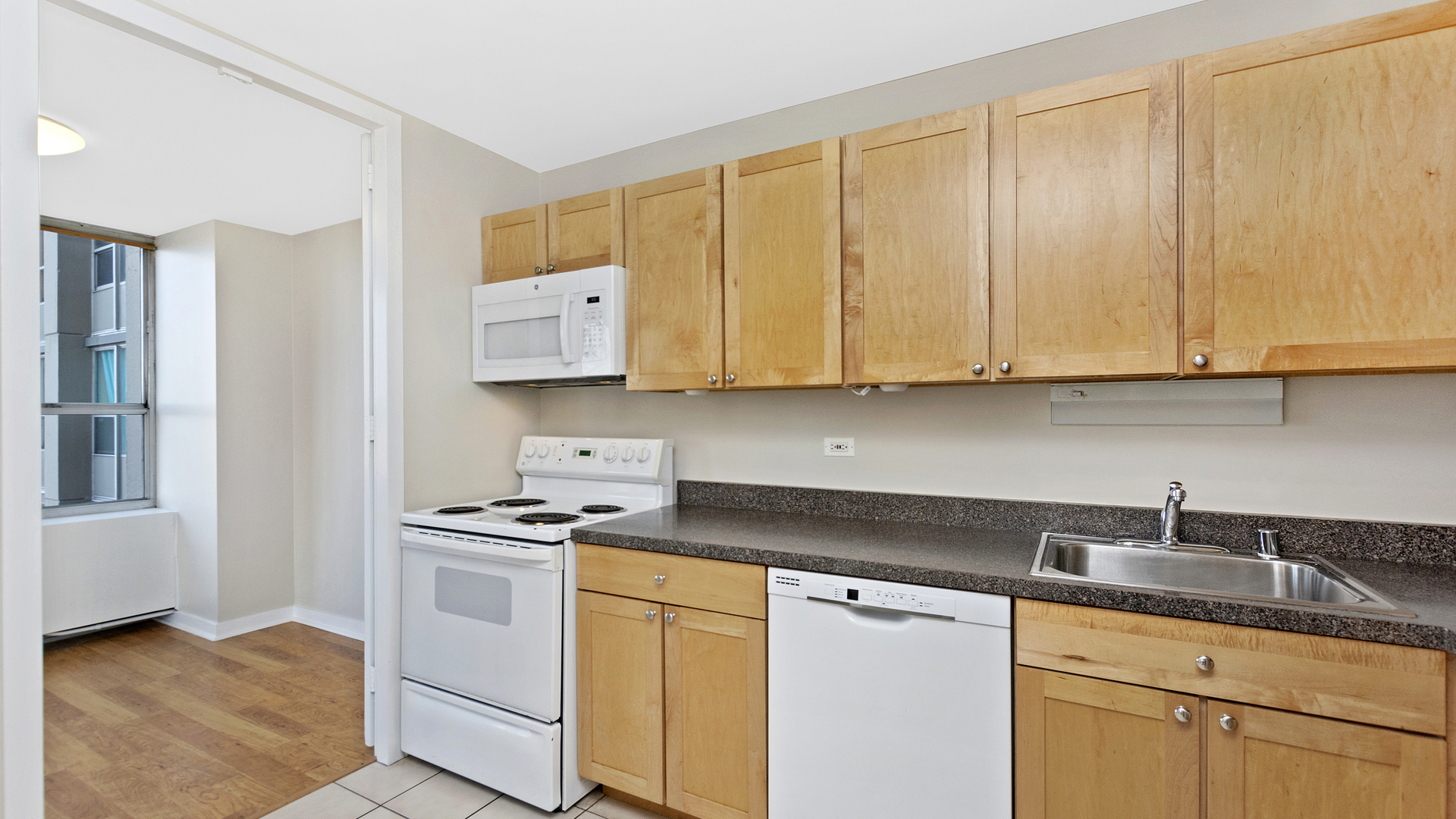 655 West Irving Park Road, Unit 710 Chicago, IL 60613 - Photo 7 of 24 a kitchen with sink cabinets and appliances