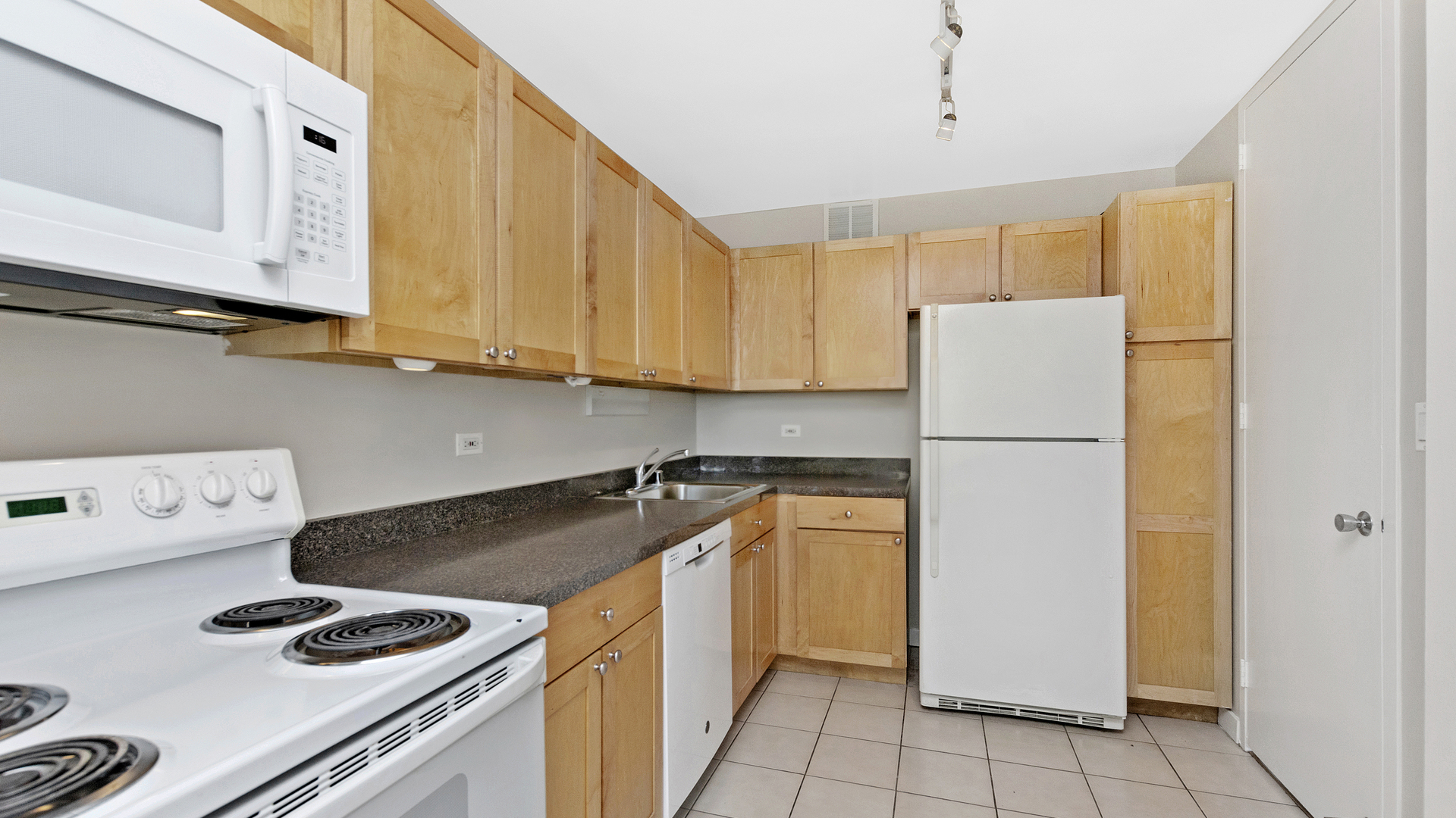 655 West Irving Park Road, Unit 710 Chicago, IL 60613 - Photo 8 of 24 a kitchen with a refrigerator and a stove