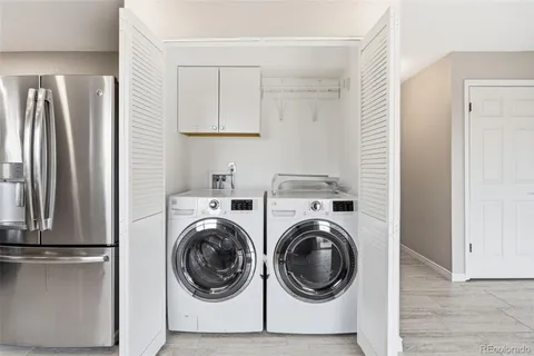 a utility room with sink dryer and washer