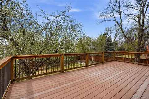 a view of balcony with wooden floor and fence