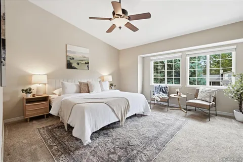 a bedroom with bed and a large window