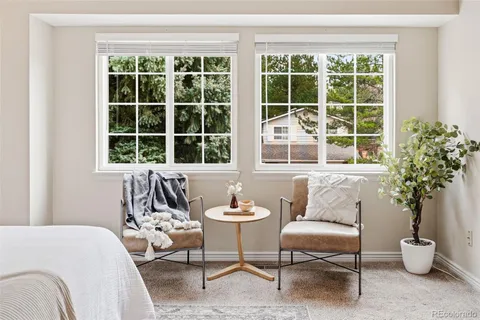 a living room with furniture and potted plant