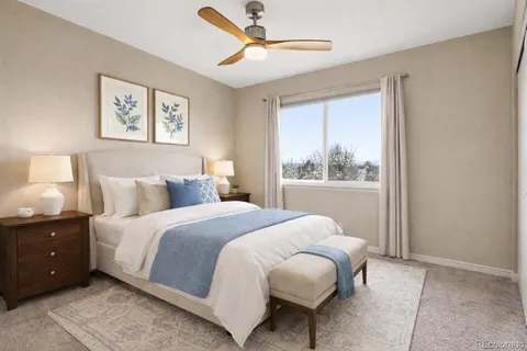 a bedroom with a large bed and a window