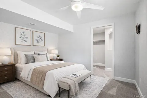 a bedroom with a bed and a painting on the wall