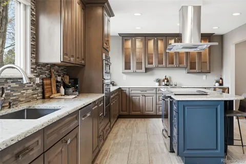 a kitchen with a sink stove and cabinets