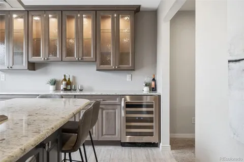 a kitchen with a granite countertop sink and cabinets