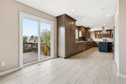 a kitchen with stainless steel appliances granite countertop a refrigerator and a stove top oven