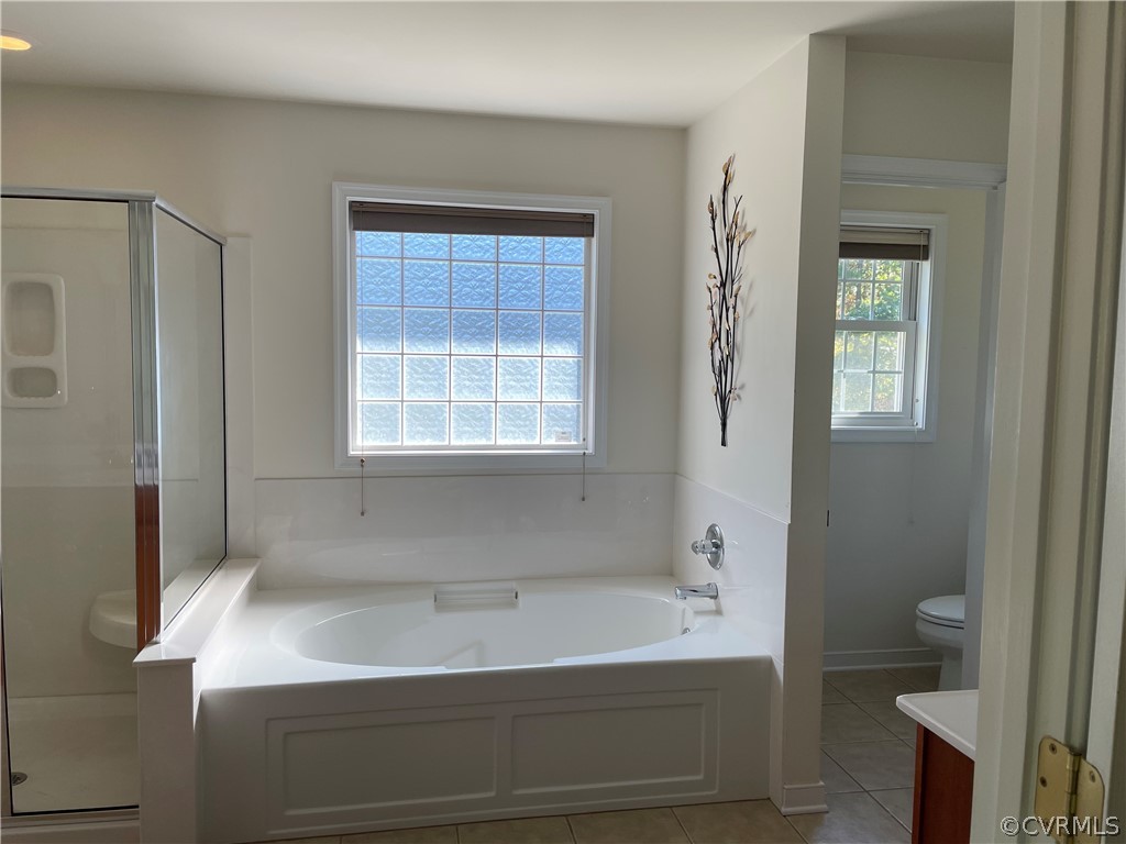 13111 Eppes Falls Road Chesterfield, VA 23838 - Photo 15 of 19 a bathroom with a bathtub and a window