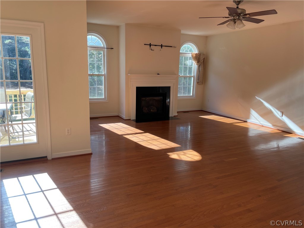 13111 Eppes Falls Road Chesterfield, VA 23838 - Photo 4 of 19 an empty room with windows and fireplace