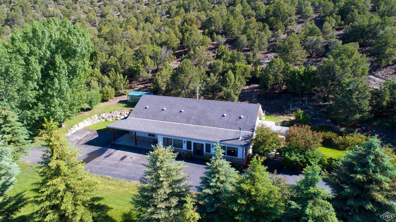 an aerial view of a house with a yard