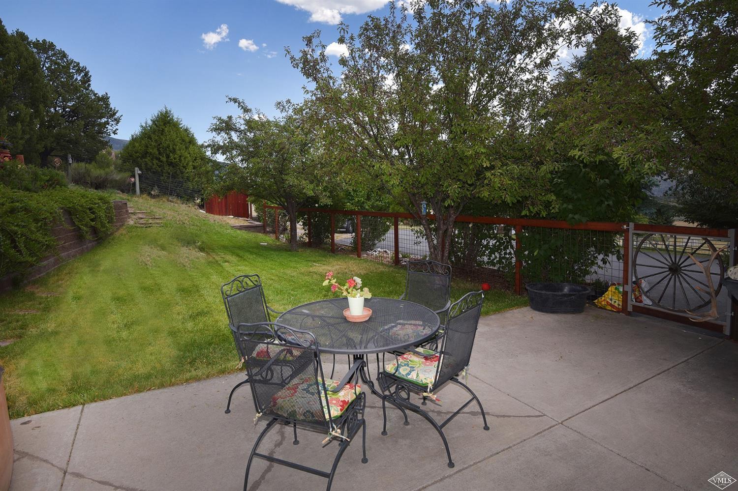 1720 Castle Peak Ranch Road Eagle, CO 81631 - Photo 13 of 25 a view of a chairs and table in patio with a yard