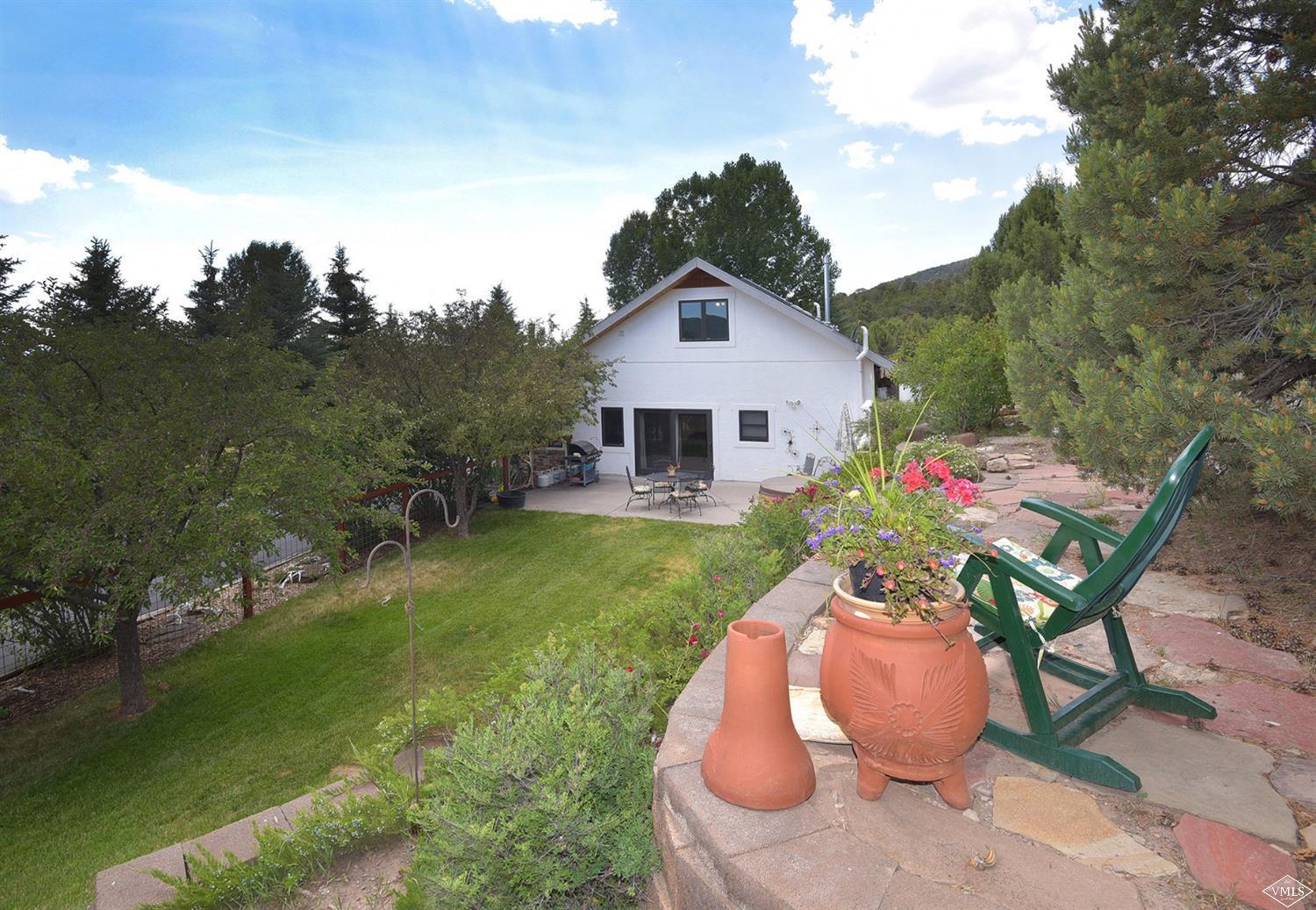 1720 Castle Peak Ranch Road Eagle, CO 81631 - Photo 15 of 25 a backyard of a house with table and chairs