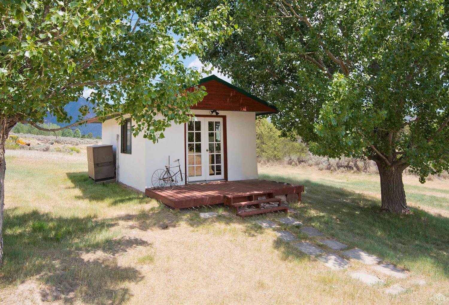 1720 Castle Peak Ranch Road Eagle, CO 81631 - Photo 17 of 25 a backyard of a house with yard and garage