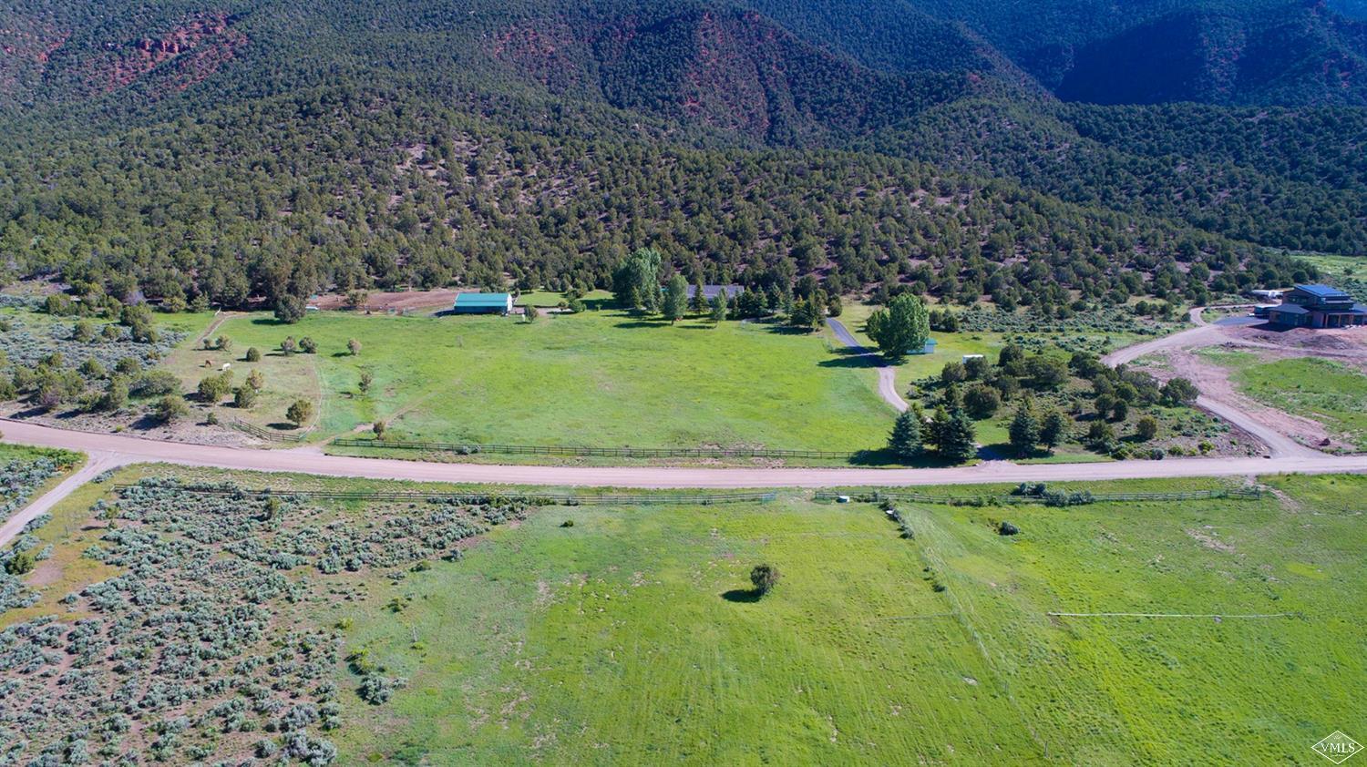1720 Castle Peak Ranch Road Eagle, CO 81631 - Photo 24 of 25 a view of a garden with a bench