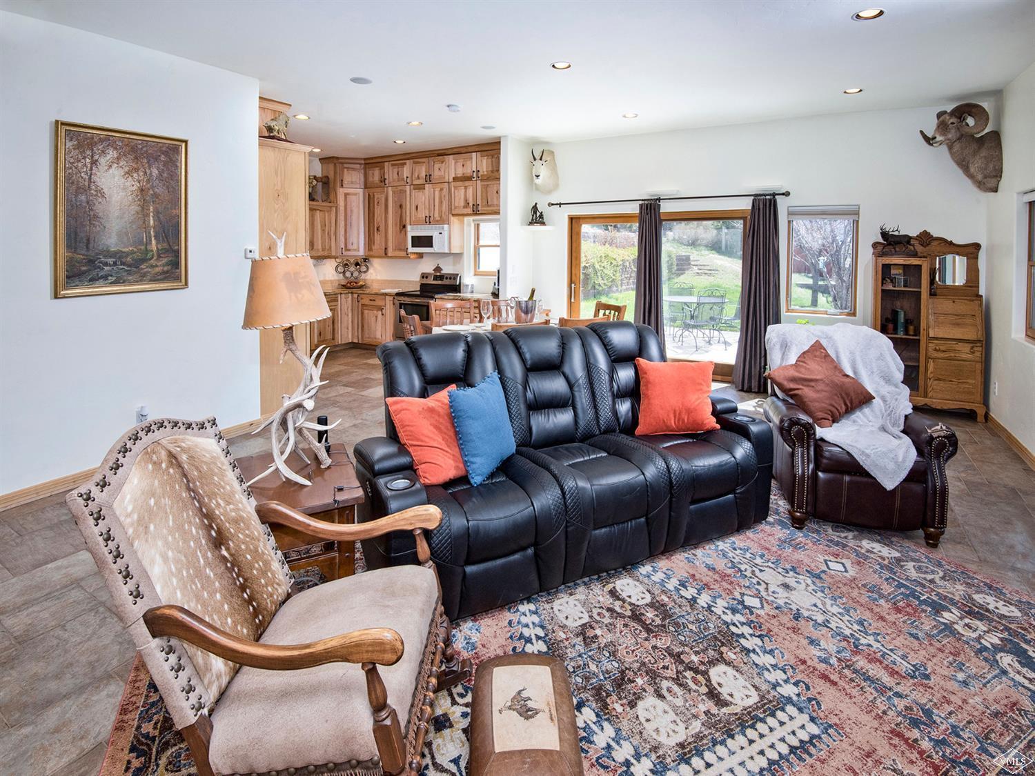 1720 Castle Peak Ranch Road Eagle, CO 81631 - Photo 4 of 25 a living room with furniture ceiling fan and a rug
