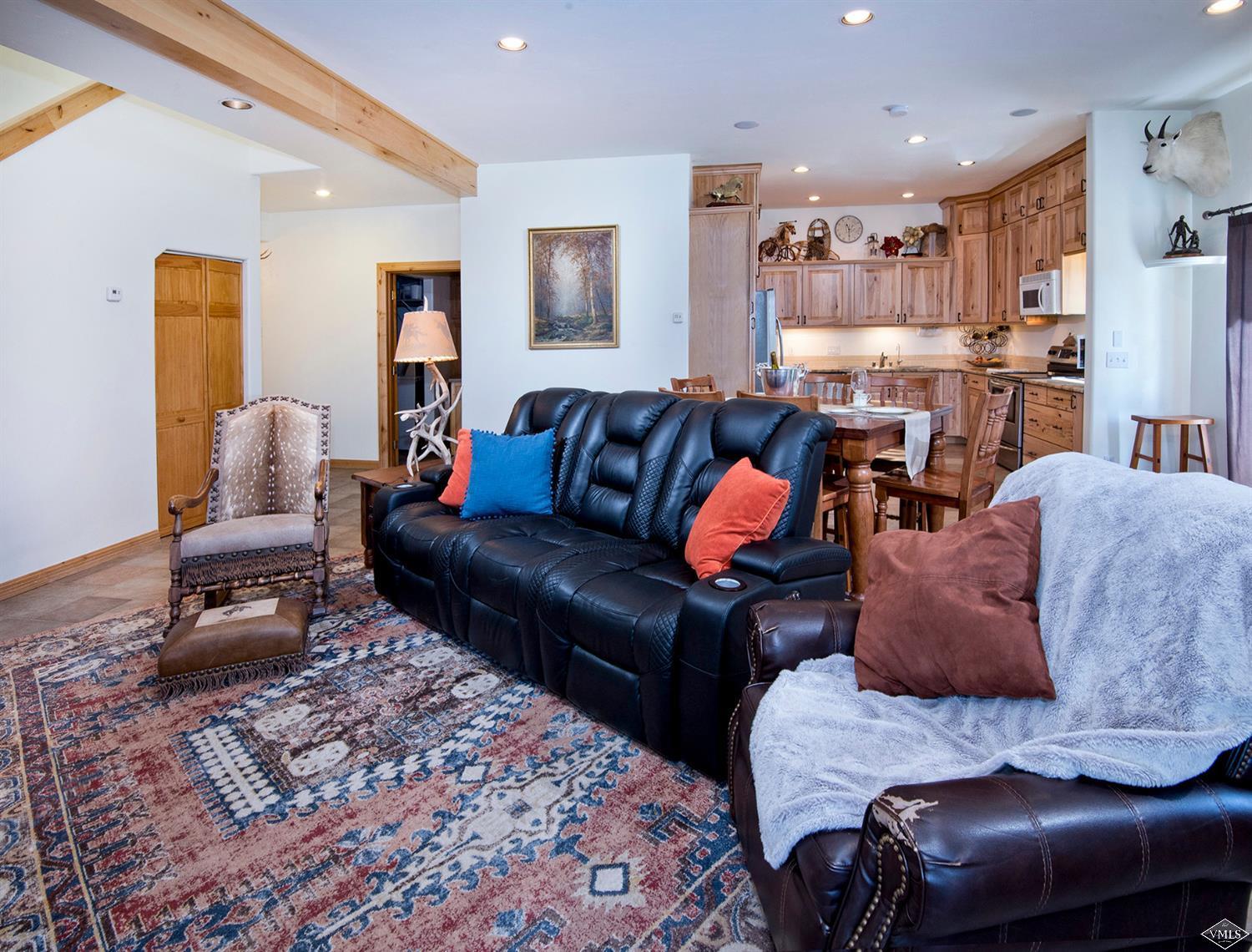 1720 Castle Peak Ranch Road Eagle, CO 81631 - Photo 5 of 25 a living room with furniture and a rug