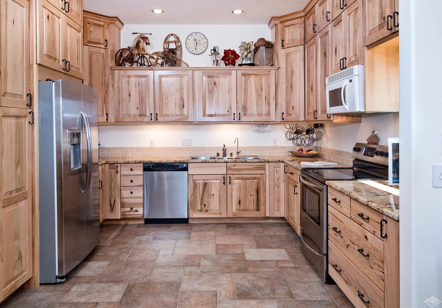 1720 Castle Peak Ranch Road Eagle, CO 81631 - Photo 7 of 25 a kitchen with stainless steel appliances granite countertop a stove and a refrigerator