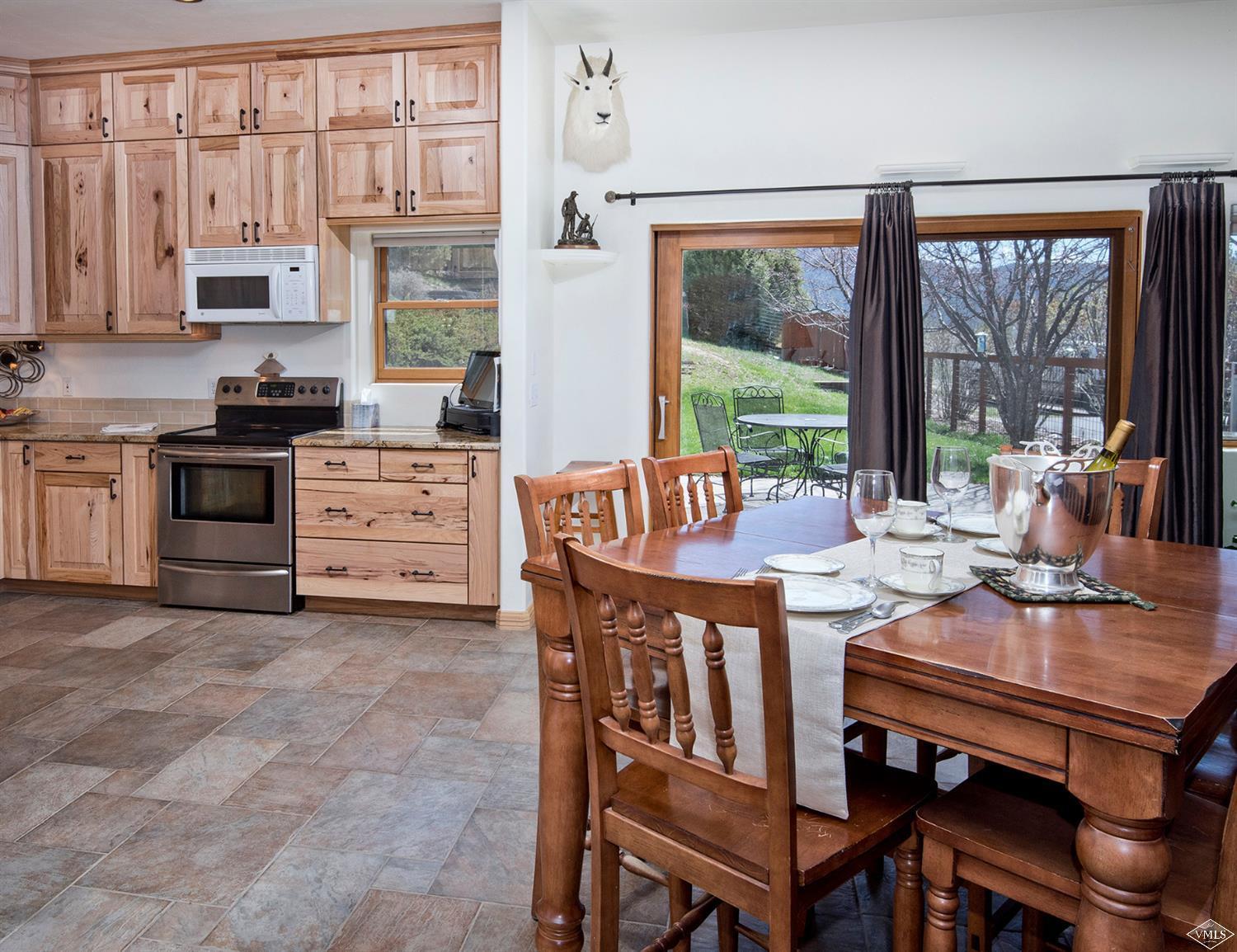 1720 Castle Peak Ranch Road Eagle, CO 81631 - Photo 8 of 25 a dining room with furniture and large windows