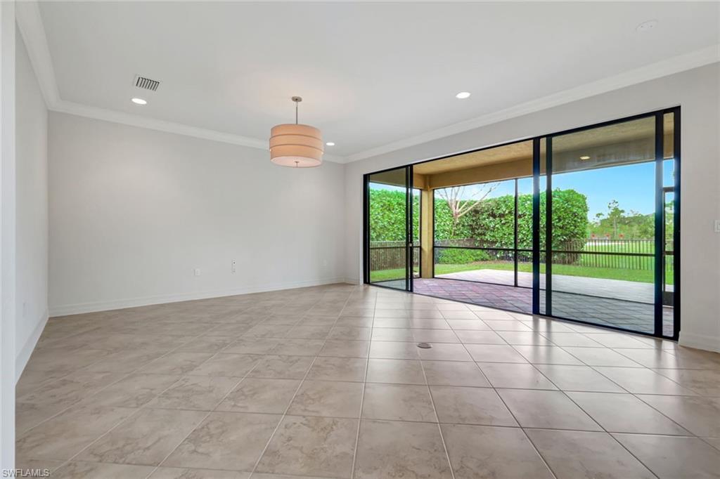 3430 Tigris Lane Naples, FL 34119 - Photo 12 of 48 a view of an empty room with a sliding door