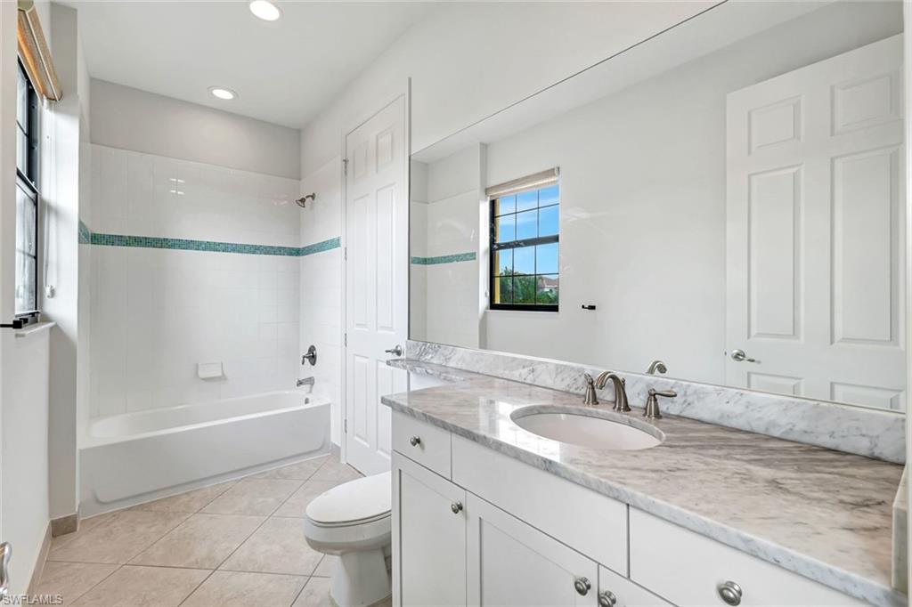3430 Tigris Lane Naples, FL 34119 - Photo 27 of 48 a bathroom with a granite countertop sink a toilet and shower