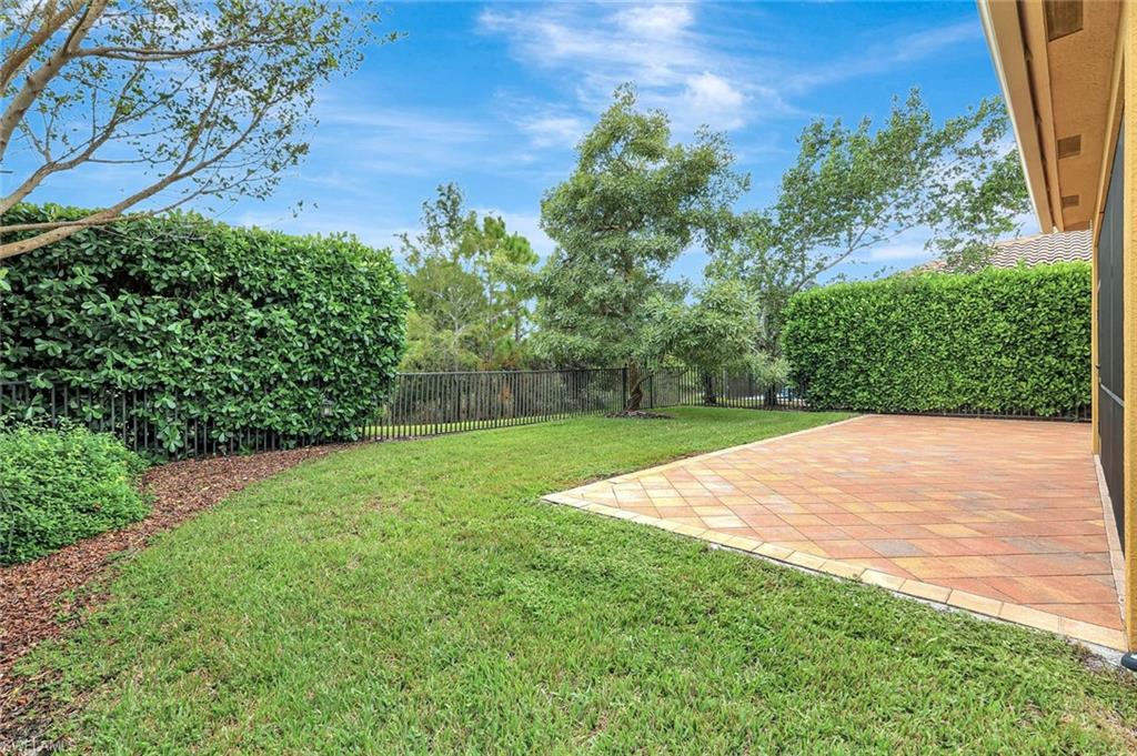 3430 Tigris Lane Naples, FL 34119 - Photo 34 of 48 a view of a yard with a tree
