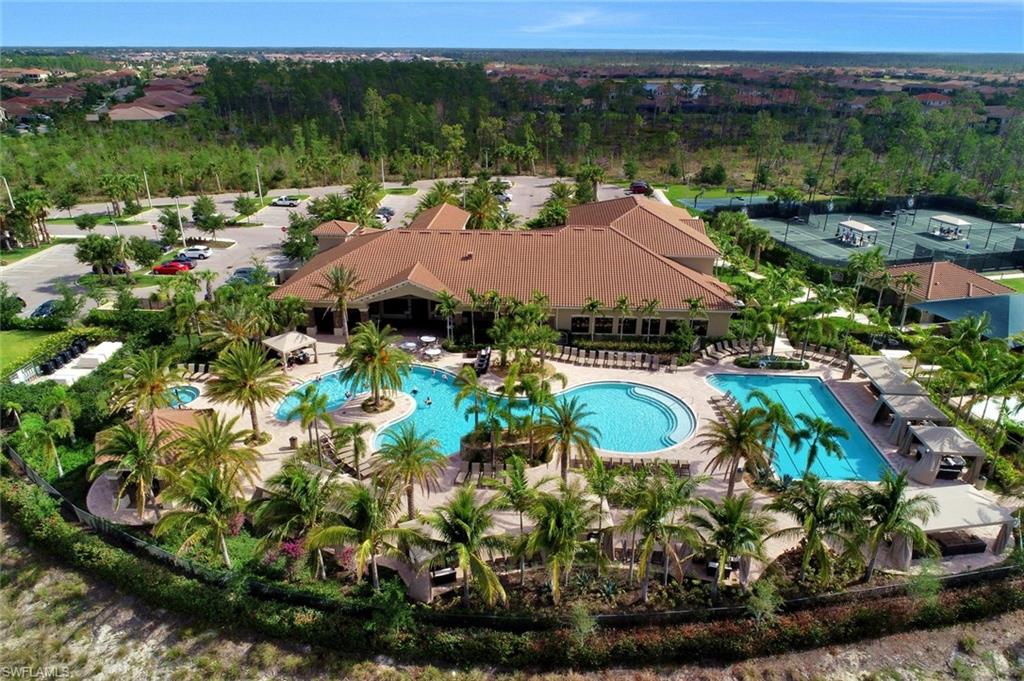 3430 Tigris Lane Naples, FL 34119 - Photo 40 of 48 a view of a lake with a house