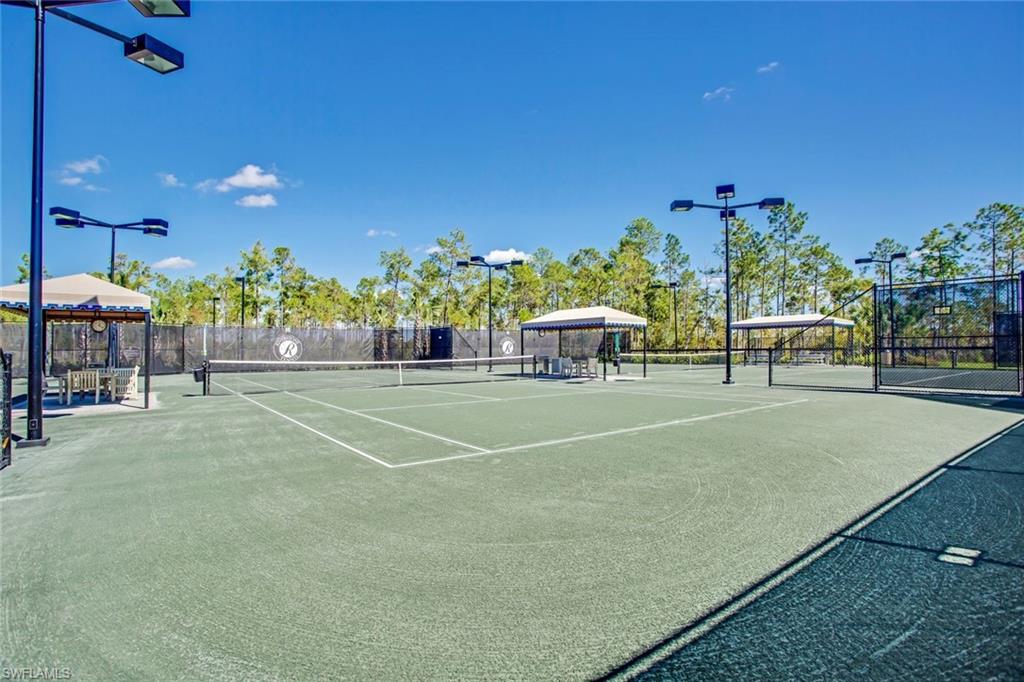 3430 Tigris Lane Naples, FL 34119 - Photo 43 of 48 a building with trees in the background