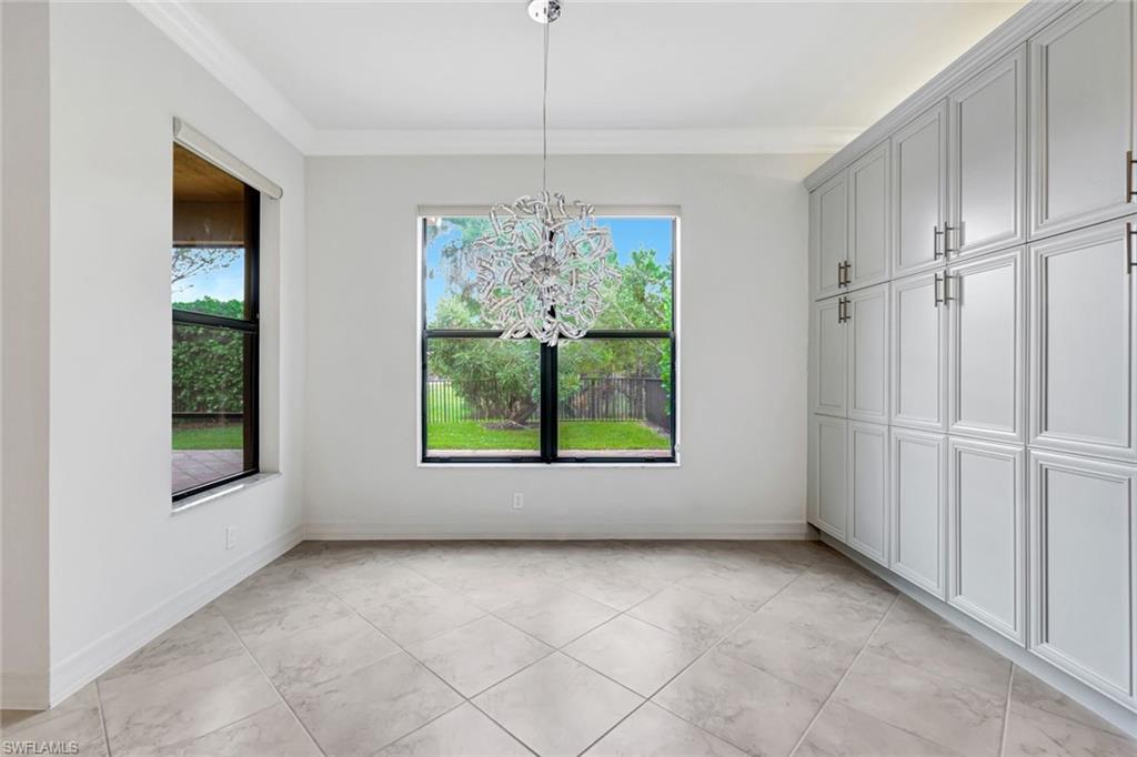 3430 Tigris Lane Naples, FL 34119 - Photo 8 of 48 a view of hallway with window and chandelier