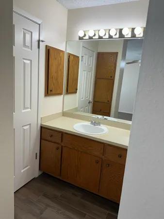a bathroom with a double vanity sink and a mirror